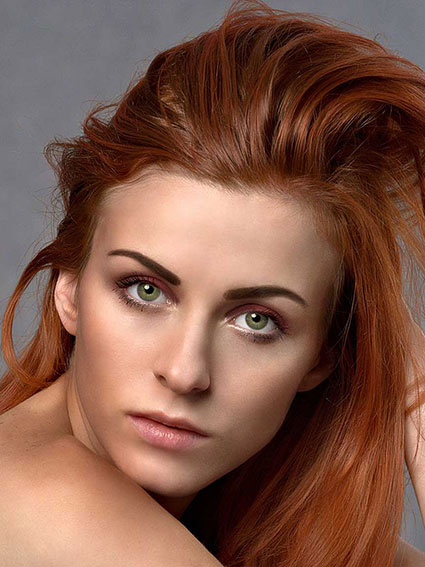 Original photo of a beautiful young woman with long red hair, facing forward and posing for a custom person illustration poster.